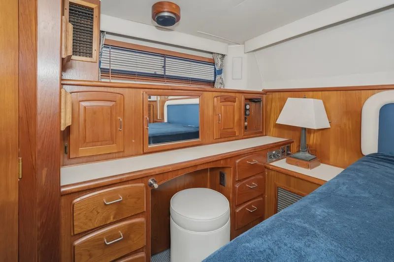 Slide: The Image of 1989 Californian 48 Cockpit Motor Yacht interior with wooden cabinetry and cozy seating. - 52