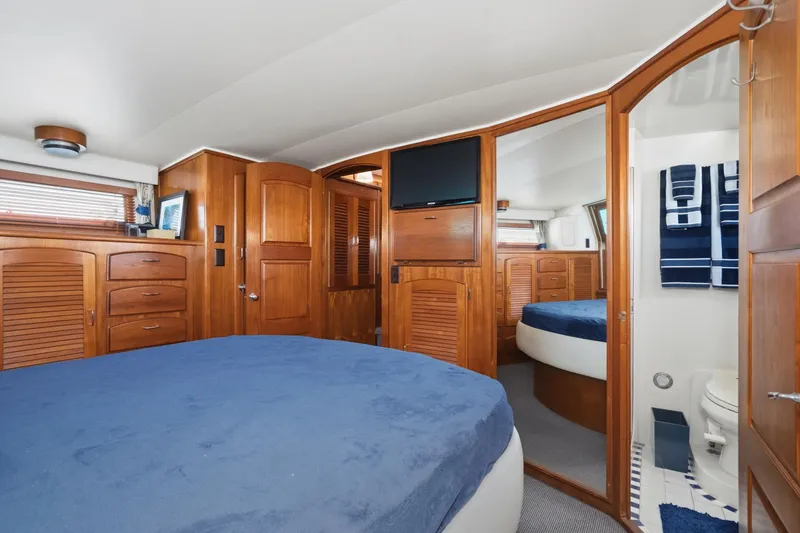 Slide: The Image of Luxurious cabin interior of 1989 Californian 48 Cockpit Motor Yacht with wood finishes. - 53