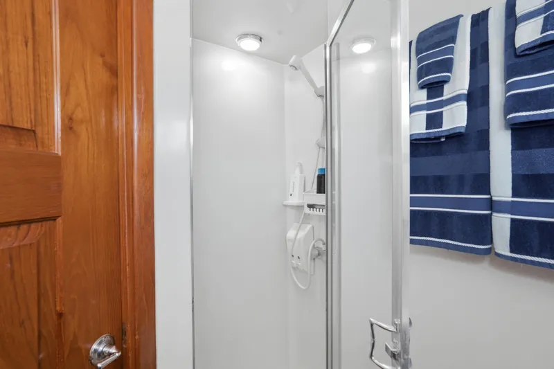 Slide: The Image of Shower area in 1989 Californian 48 Cockpit Motor Yacht with blue striped towels. - 56