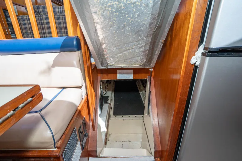 Slide: The Image of Interior view of 1989 Californian 48 Cockpit Motor Yacht with stairs and seating area. - 60