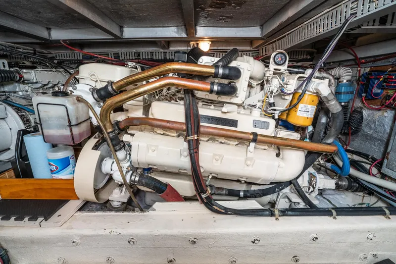 Slide: The Image of Engine room of 1989 Californian 48 Cockpit Motor Yacht with visible machinery and components. - 65