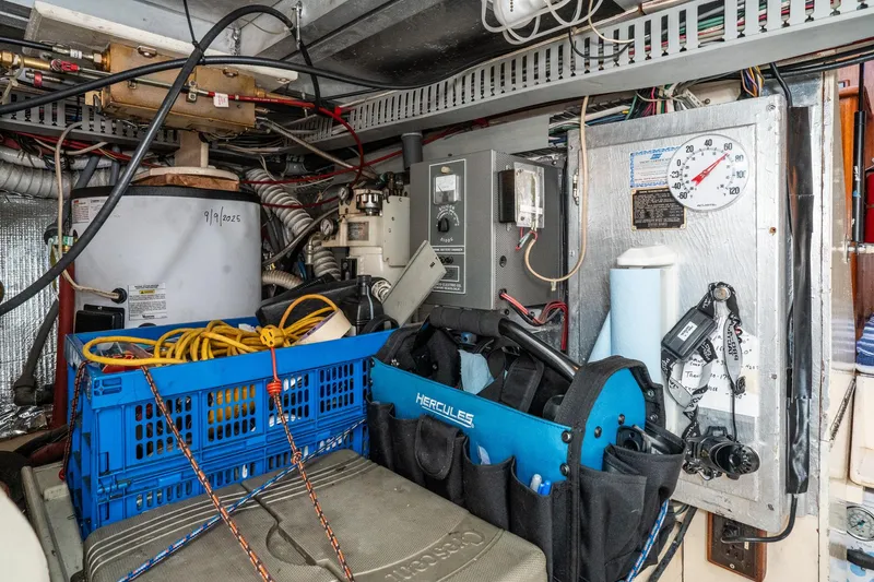 Slide: The Image of Engine room of 1989 Californian 48 Cockpit Motor Yacht with tools and equipment. - 68