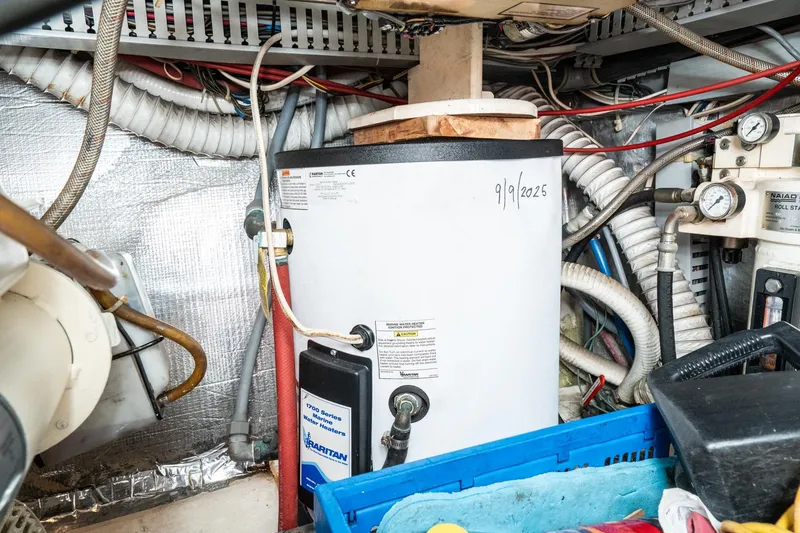 Slide: The Image of Engine room of 1989 Californian 48 Cockpit Motor Yacht with water heater and wiring. - 69