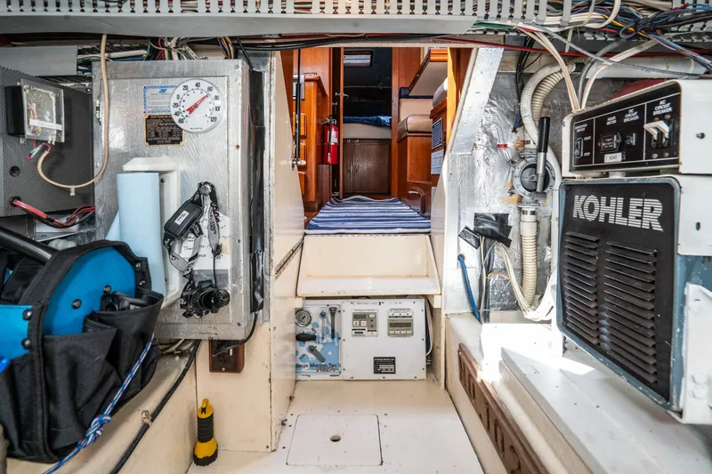 Slide: The Image of Engine room of 1989 Californian 48 Cockpit Motor Yacht with Kohler generator and control panels. - 70