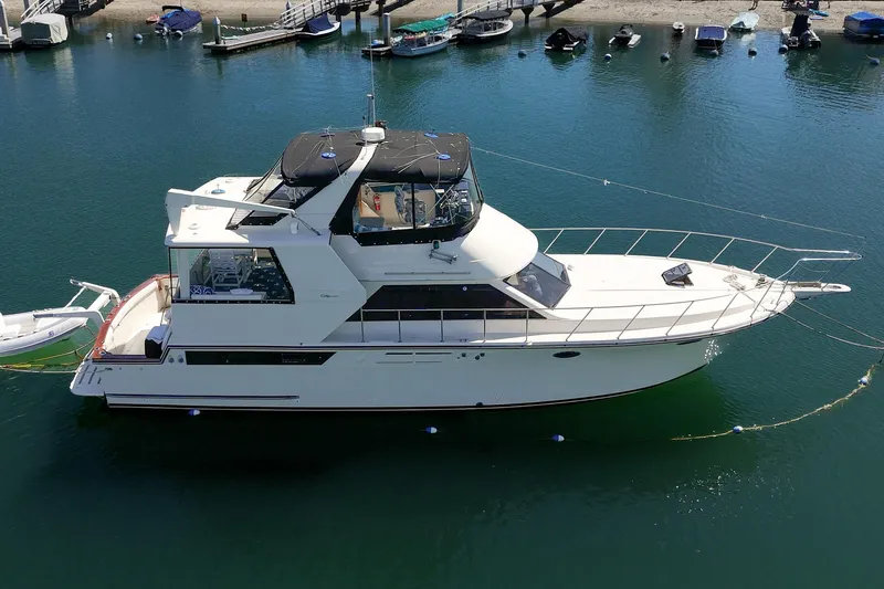 Slide: The Image of 1989 Californian 48 Cockpit Motor Yacht docked in a marina, aerial view. - 9