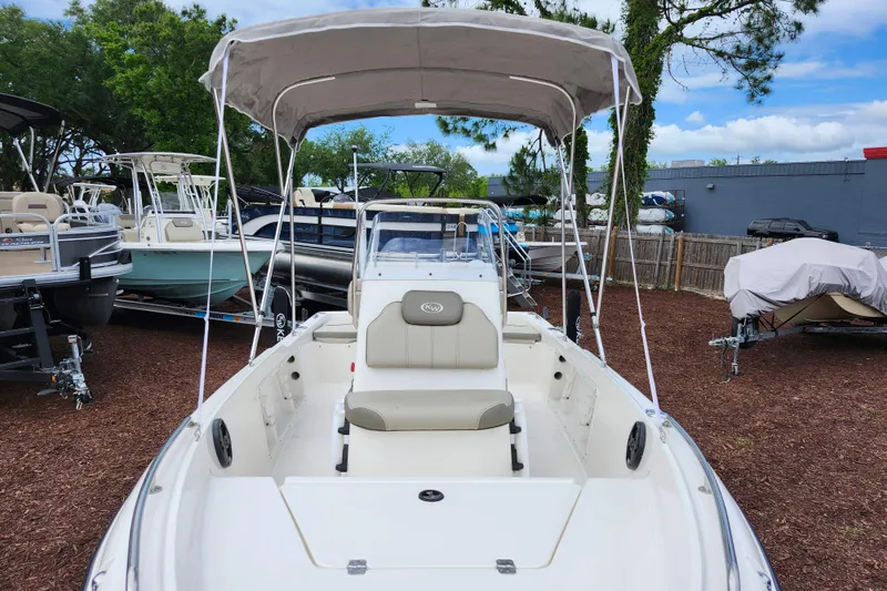 Slide: The Image of 2024 Key West 1720 Center Console boat with canopy in a marina setting. - 11