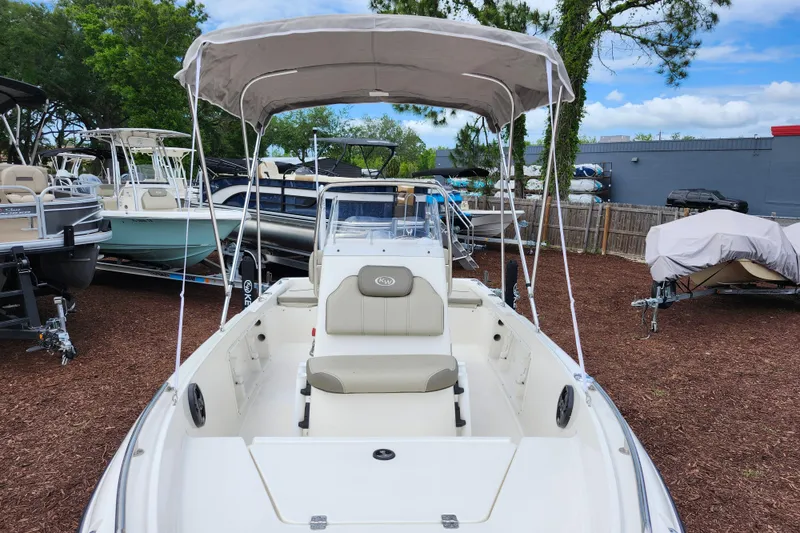 Slide: The Image of 2024 Key West 1720 Center Console boat with canopy, displayed outdoors among other boats. - 13