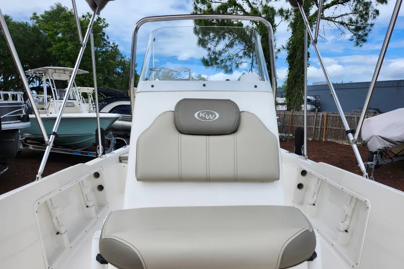 Slide: The Image of 2024 Key West 1720 Center Console boat with beige seating and console, outdoors. - 20