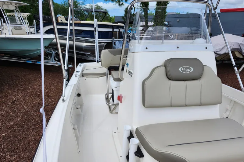Slide: The Image of 2024 Key West 1720 Center Console boat with beige seating and sleek design. - 22