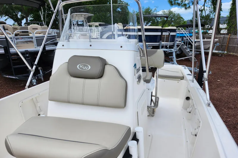 Slide: The Image of 2024 Key West 1720 Center Console boat with beige seating and sleek design. - 23