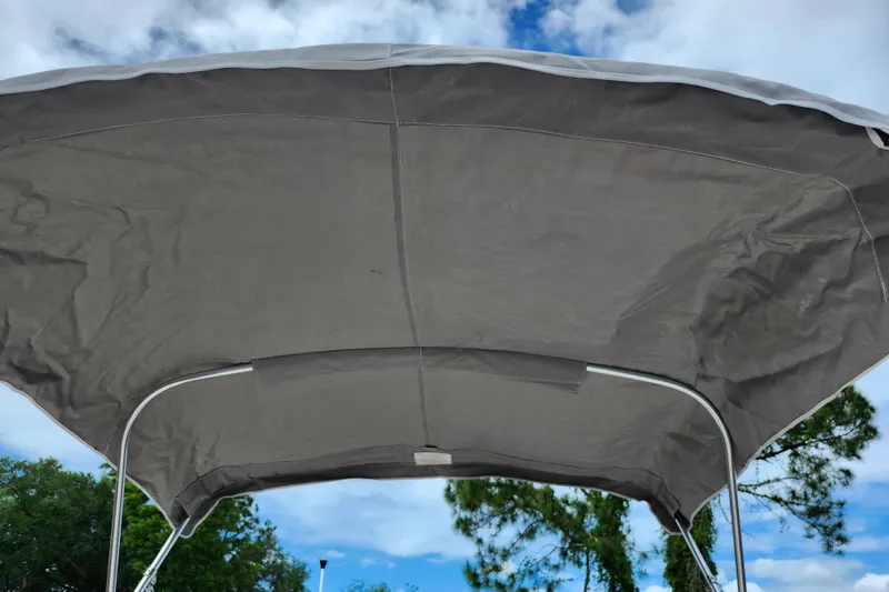 Slide: The Image of Bimini top of 2024 Key West 1720 Center Console boat against blue sky. - 24