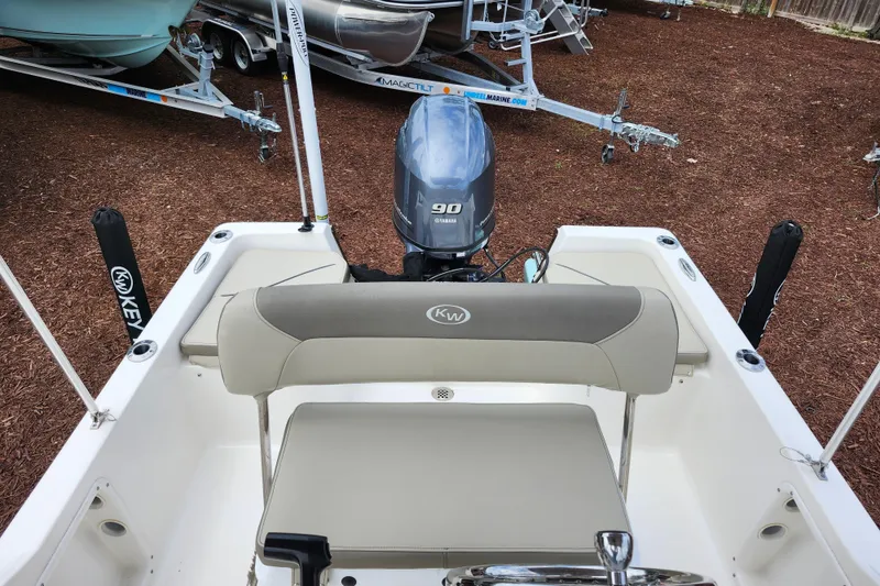 Slide: The Image of 2024 Key West 1720 Center Console boat with Yamaha 90 engine, parked on mulch. - 27
