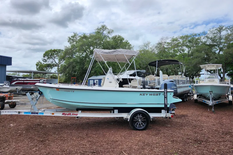 Slide: The Image of 2024 Key West 1720 Center Console boat on trailer, parked outdoors under cloudy sky. - 3