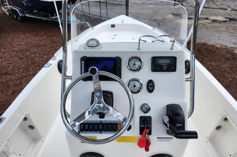 Slide: The Image of 2024 Key West 1720 Center Console boat dashboard with steering wheel and controls. - 30