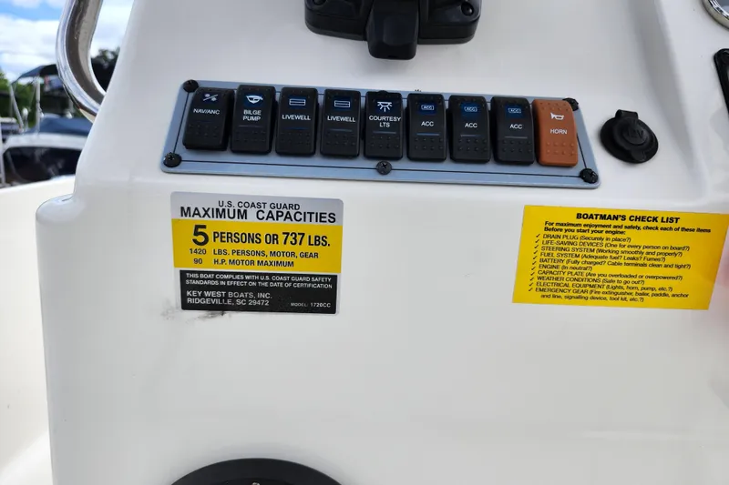 Slide: The Image of Control panel of 2024 Key West 1720 Center Console boat with capacity and safety labels. - 31