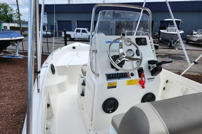 Slide: The Image of 2024 Key West 1720 Center Console boat with steering wheel and control panel. - 38