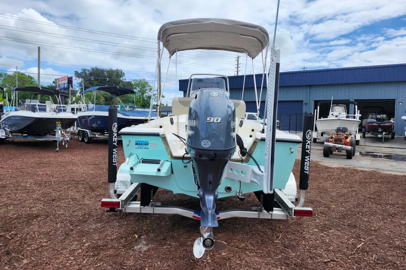 Slide: The Image of 2024 Key West 1720 Center Console boat with Yamaha 90 engine on display outdoors. - 5