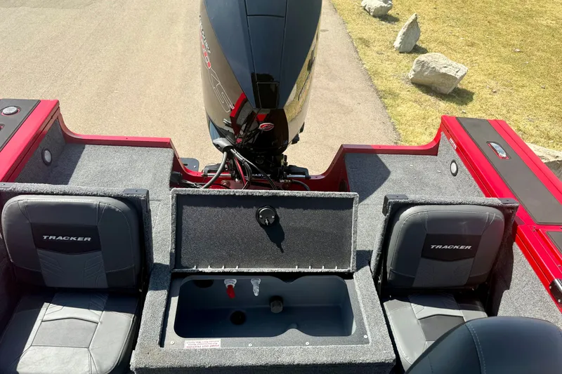 Slide: The Image of 2026 Tracker Targa V-18 Combo boat interior with motor and seating. - 15