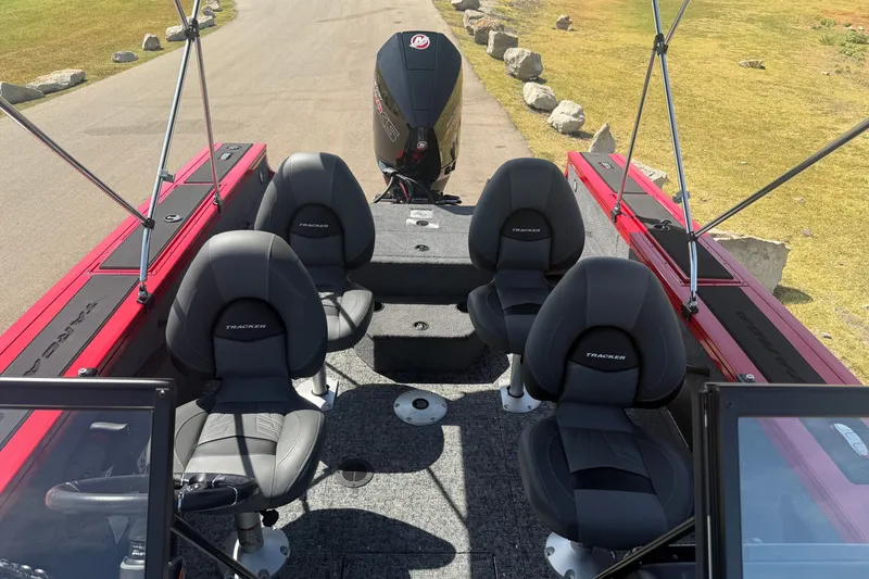 Slide: The Image of 2026 Tracker Targa V-18 Combo boat interior with four seats and outboard motor. - 16