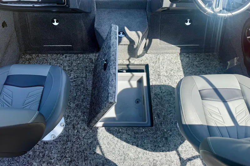Slide: The Image of Interior of 2026 Tracker Targa V-18 Combo boat with open storage compartment and two seats. - 14