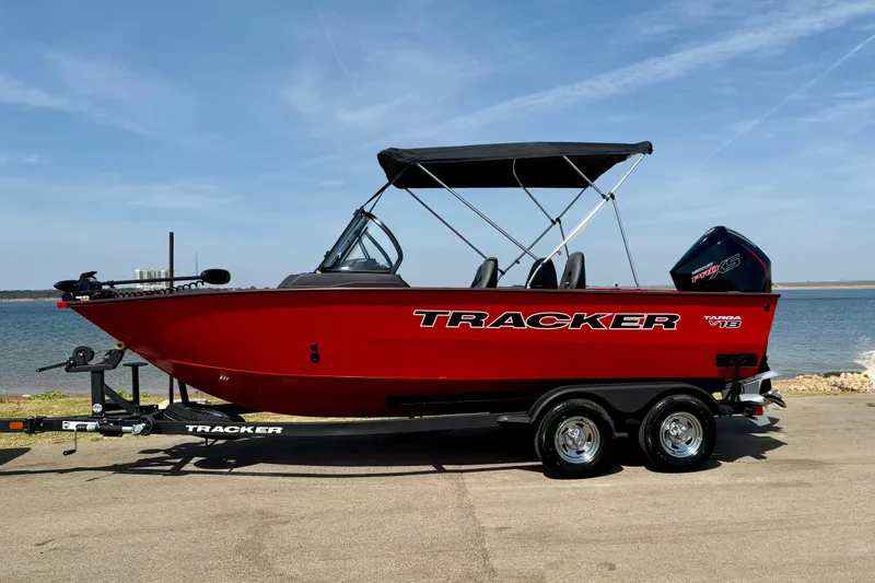 The Image of 2026 Tracker Targa V-18 Combo boat, red, on trailer by a lake. - 0