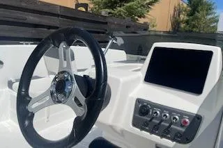 Slide: The Image of 2026 Tahoe T18 boat dashboard with steering wheel and control panel. - 5