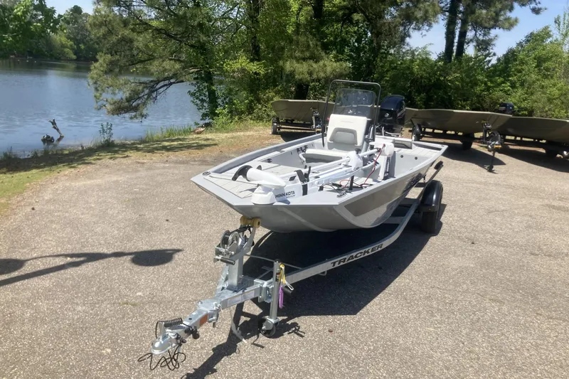 Slide: The Image of 2026 Tracker Bass Tracker Classic CC boat on trailer by a lake. - 2