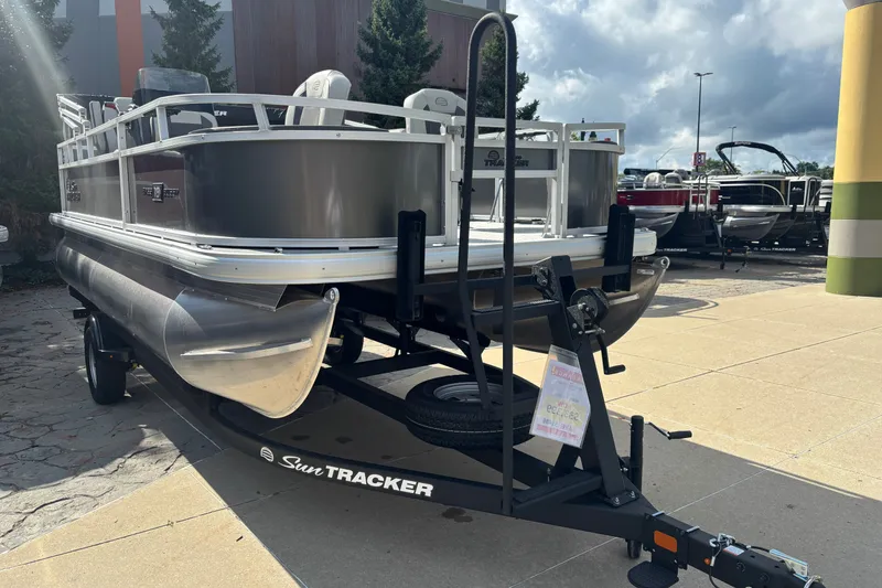Slide: The Image of 2026 Sun Tracker Bass Buggy 18 DLX pontoon boat on trailer, outdoor display. - 36