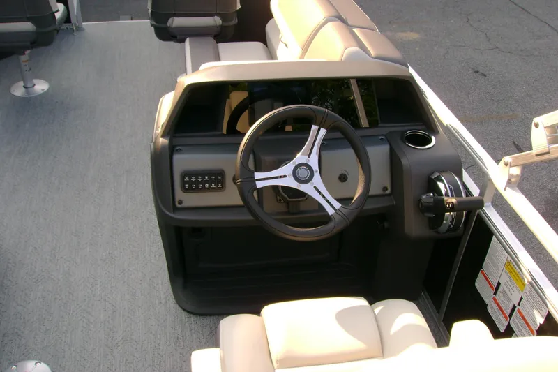 Slide: The Image of 2026 Sun Tracker Fishin' Barge 20 DLX helm with steering wheel and controls. - 7