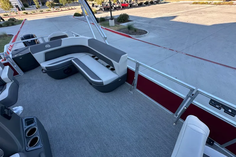Slide: The Image of 2026 Sun Tracker Bass Buggy 18 DLX pontoon boat interior with seating and cup holders. - 14