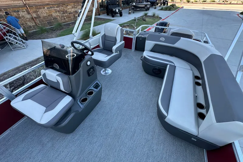 Slide: The Image of 2026 Sun Tracker Bass Buggy 18 DLX pontoon boat interior with seating and steering console. - 15