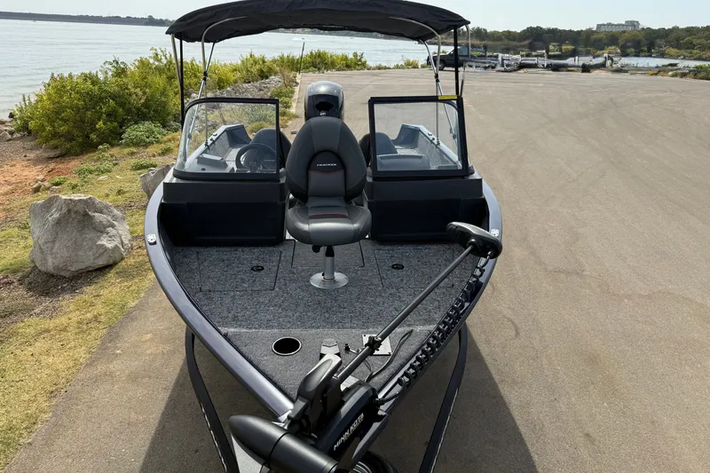 Slide: The Image of 2026 Tracker Pro Guide V-175 WT boat parked near a scenic lakeside. - 13