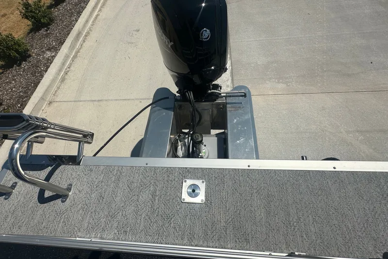 Slide: The Image of 2026 Sun Tracker Fishin' Barge 20 DLX with outboard motor, viewed from above. - 20