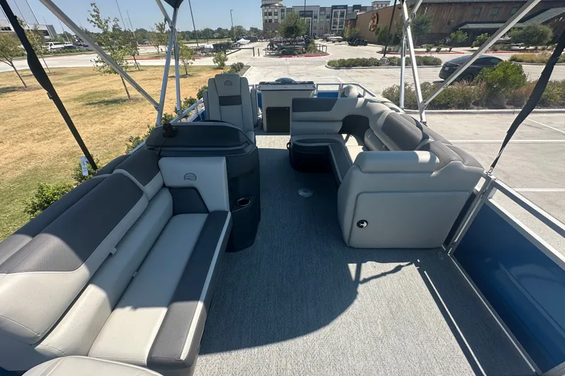 Slide: The Image of 2026 Sun Tracker Fishin' Barge 20 DLX interior with spacious seating and modern design. - 16