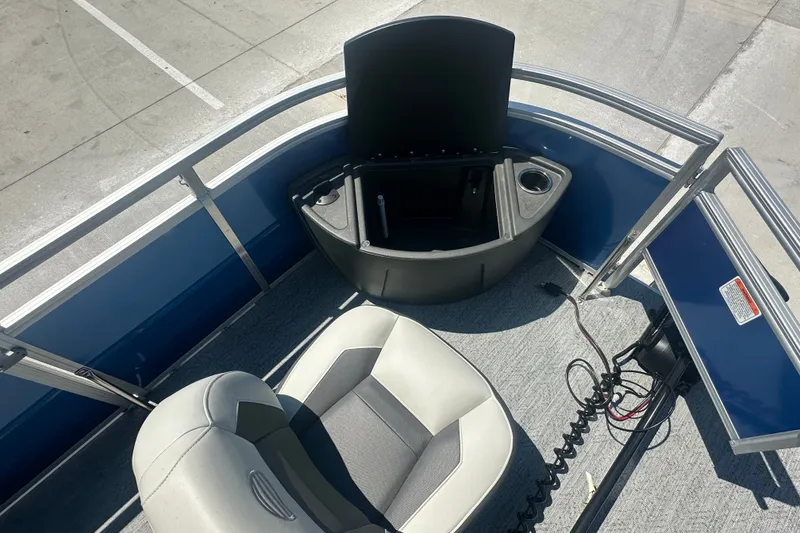 Slide: The Image of 2026 Sun Tracker Fishin' Barge 20 DLX interior with seating and storage compartment. - 26