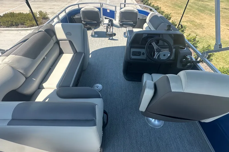 Slide: The Image of Interior of 2026 Sun Tracker Fishin' Barge 20 DLX pontoon boat with seating and steering console. - 24