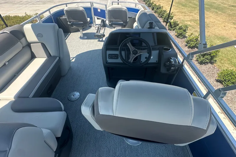 Slide: The Image of 2026 Sun Tracker Fishin' Barge 20 DLX interior with seating and steering console. - 23