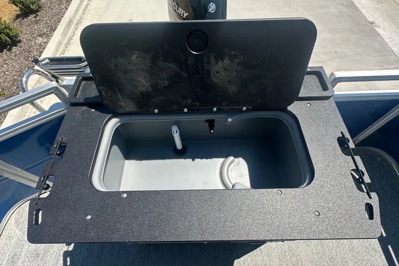 Slide: The Image of Open storage compartment on 2026 Sun Tracker Fishin' Barge 20 DLX boat. - 21