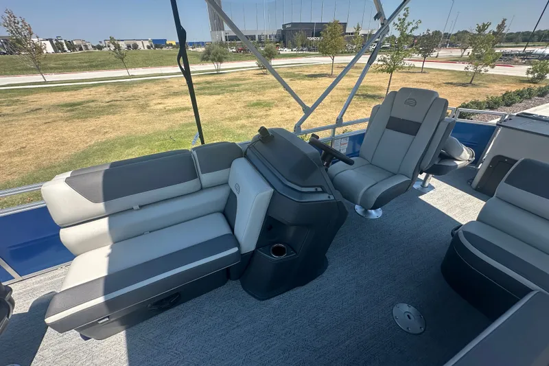 Slide: The Image of 2026 Sun Tracker Fishin' Barge 20 DLX interior with seating and steering console. - 18