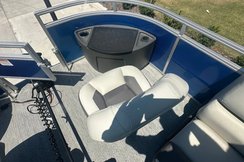 Slide: The Image of 2026 Sun Tracker Fishin' Barge 20 DLX interior with seating and fishing station. - 25