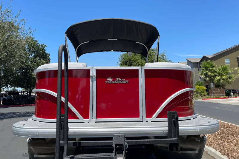 Slide: The Image of 2026 Sun Tracker Party Barge 20 DLX pontoon boat with red exterior and canopy. - 4