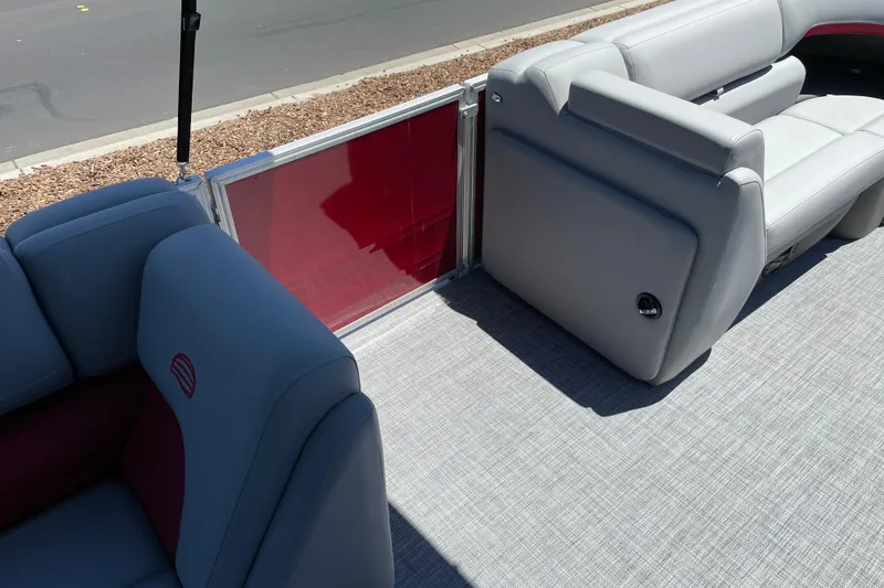 Slide: The Image of 2026 Sun Tracker Party Barge 20 DLX interior with gray seating and red accents. - 17