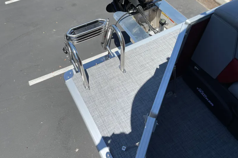 Slide: The Image of 2026 Sun Tracker Party Barge 20 DLX boat deck with ladder and seating area. - 16