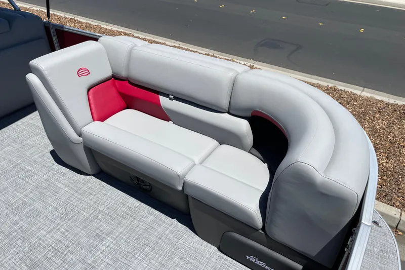 Slide: The Image of 2026 Sun Tracker Party Barge 20 DLX with plush gray seating and red accents. - 6
