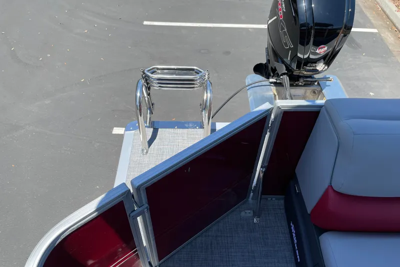 Slide: The Image of 2026 Sun Tracker Party Barge 20 DLX with outboard motor and rear entry ladder. - 15