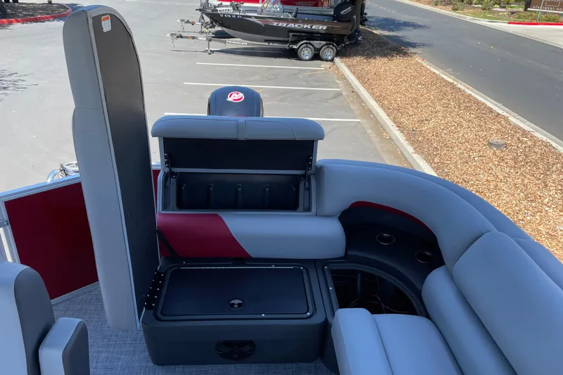 Slide: The Image of 2026 Sun Tracker Party Barge 20 DLX interior with open storage compartment. - 13