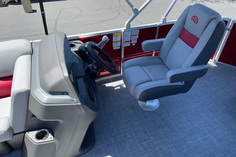 Slide: The Image of 2026 Sun Tracker Party Barge 20 DLX interior with captain's chair and steering console. - 10