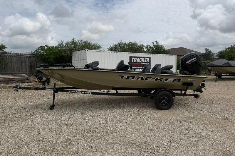 The Image of 2026 Tracker Pro Team 175 boat on trailer, parked outdoors under cloudy sky. - 0
