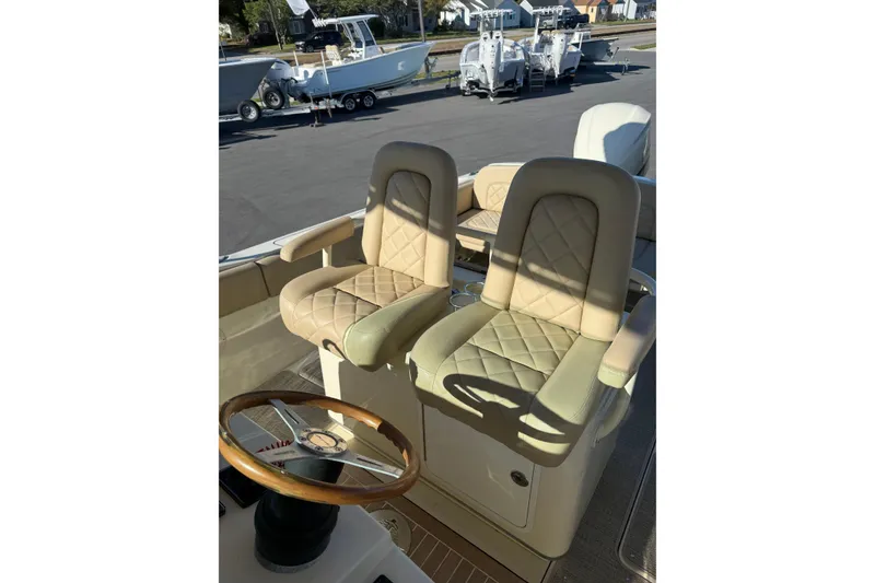 Slide: The Image of Luxurious seating on 2015 Chris-Craft 291 Catalina boat with elegant steering wheel. - 10