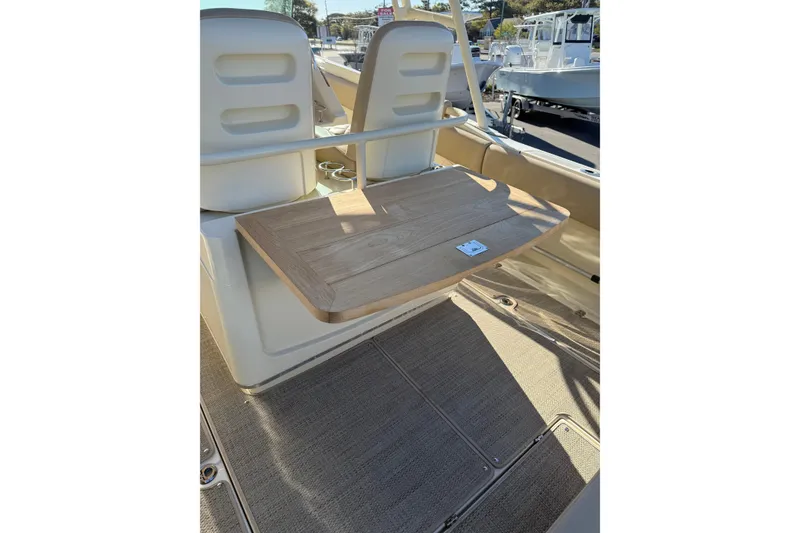 Slide: The Image of 2015 Chris-Craft 291 Catalina boat interior with wooden table and seating. - 11